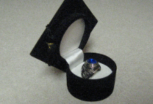 Class ring in a graduation cap